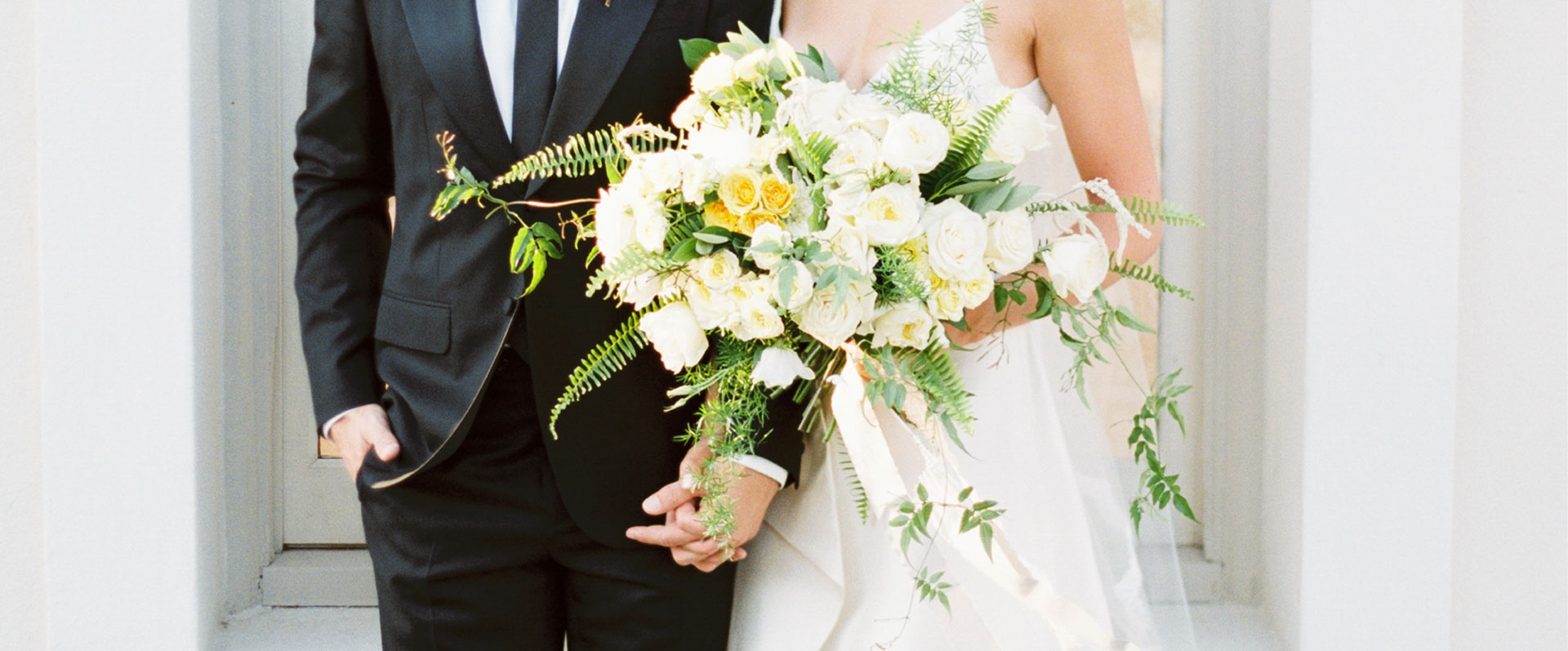 bridal bouquet with bride and groom