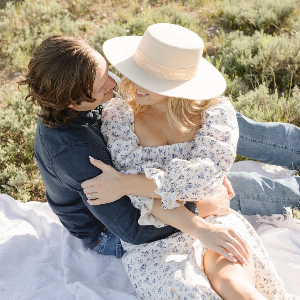 couple sitting on the grass- engagement photo ideas