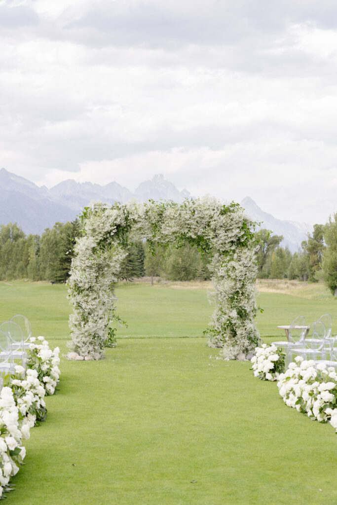 stunning flower arch with stunning mountain views in the background
