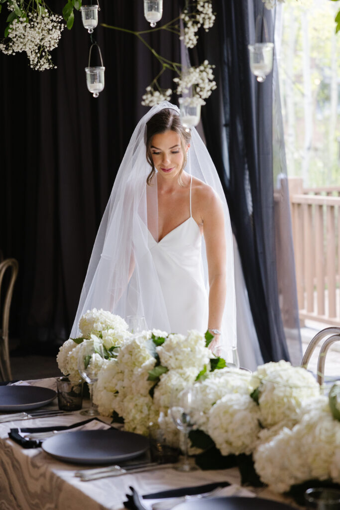 bride making final adjustments to the tables before her guests arrive