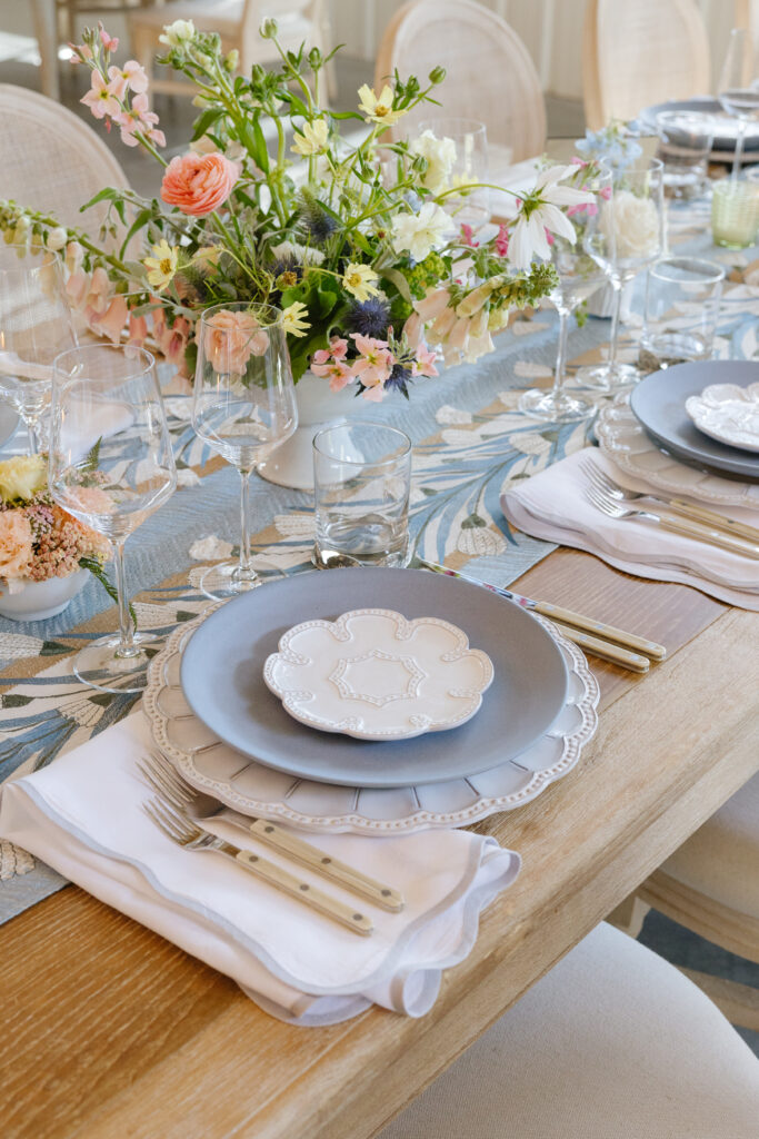 lovely table set up with blue plates and gold cutlery