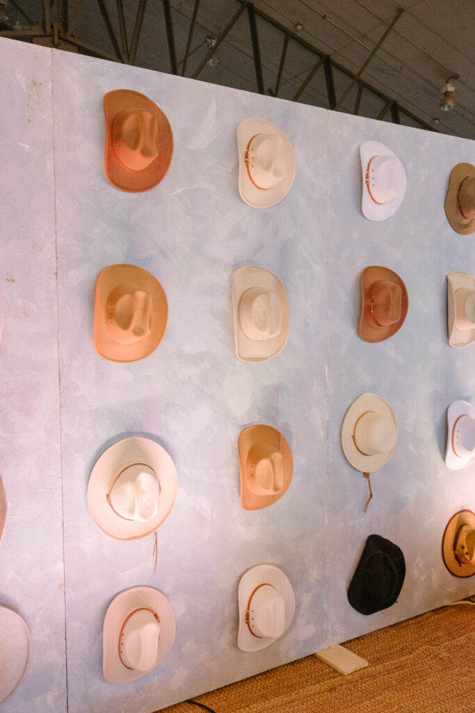 cowboy hat wall behind the stage at Diamond Cross Ranch