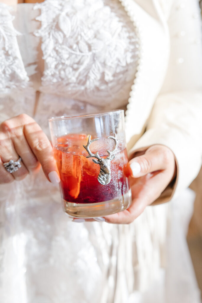 bride holding a delicious drink at her wedding at Diamond Cross Ranch
