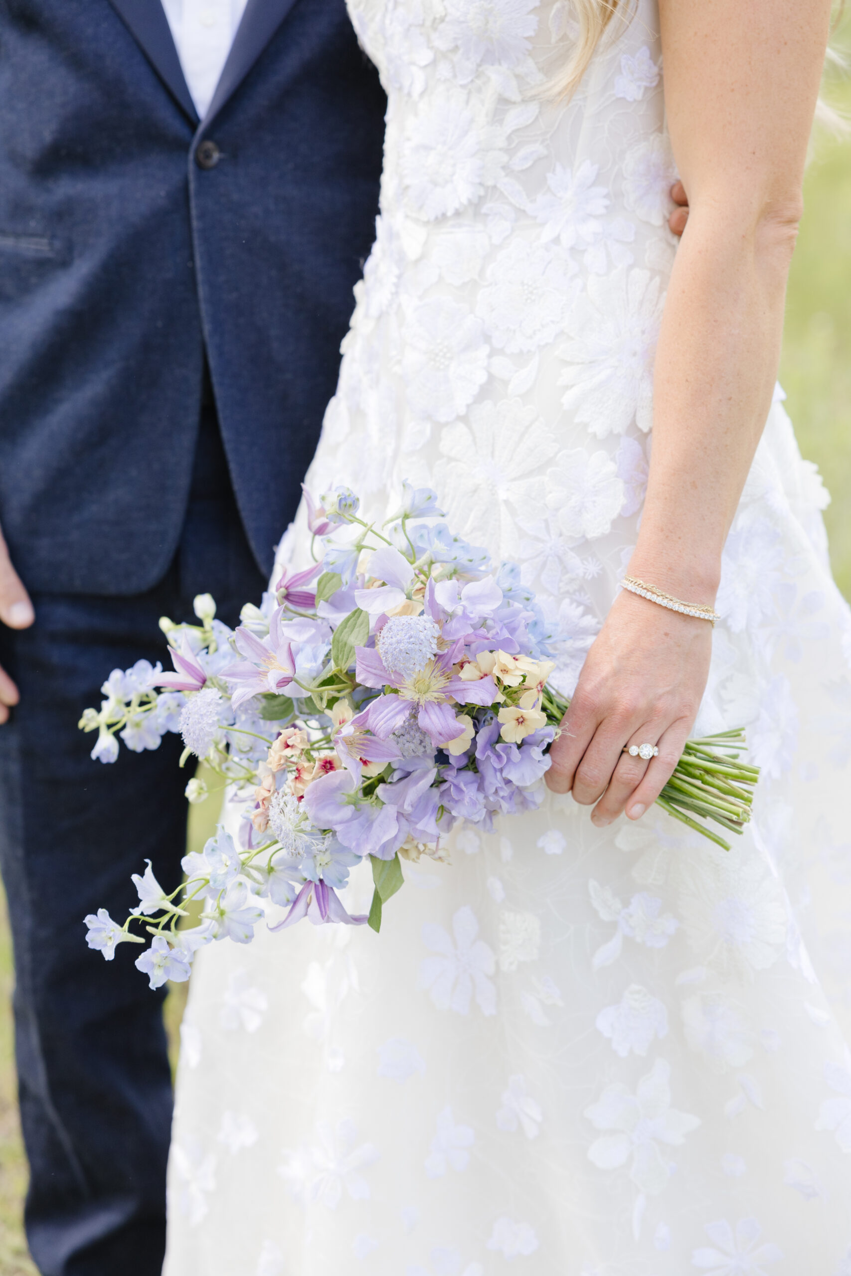 bride and groom standing together with a beautiful pastel bouquet during their Grand Teton Elopement 