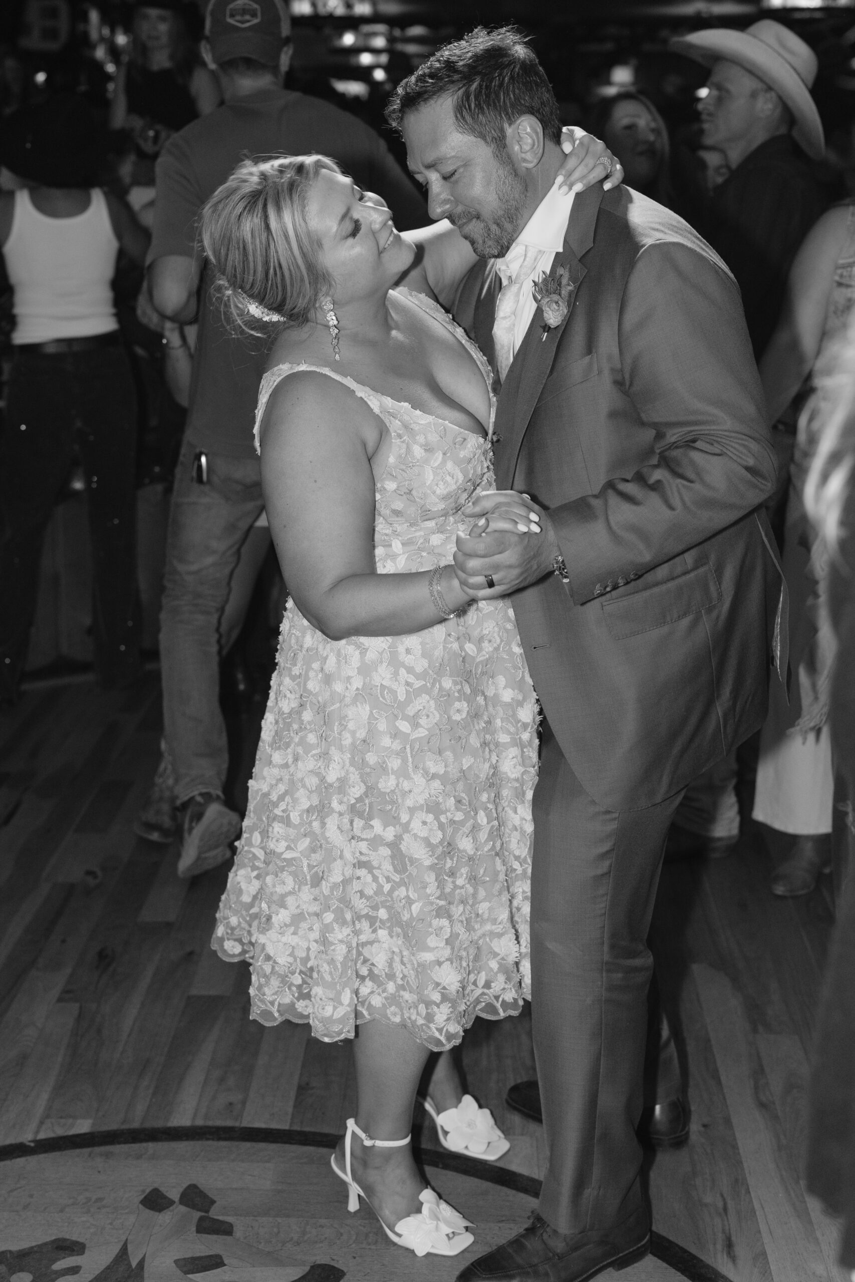black and white photo of the bride and groom dancing