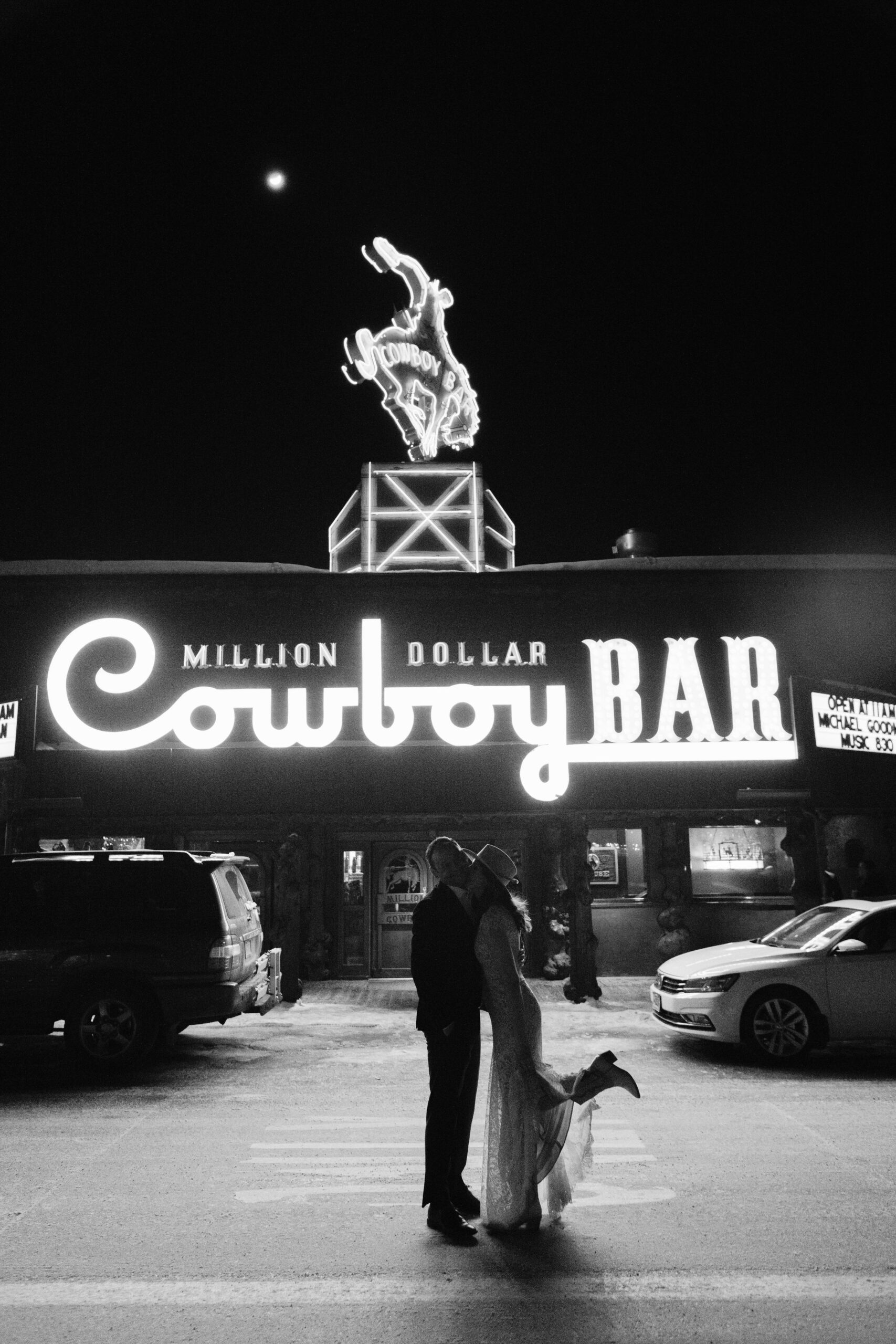 bride and groom kissing outside the million dollar cowboy bar