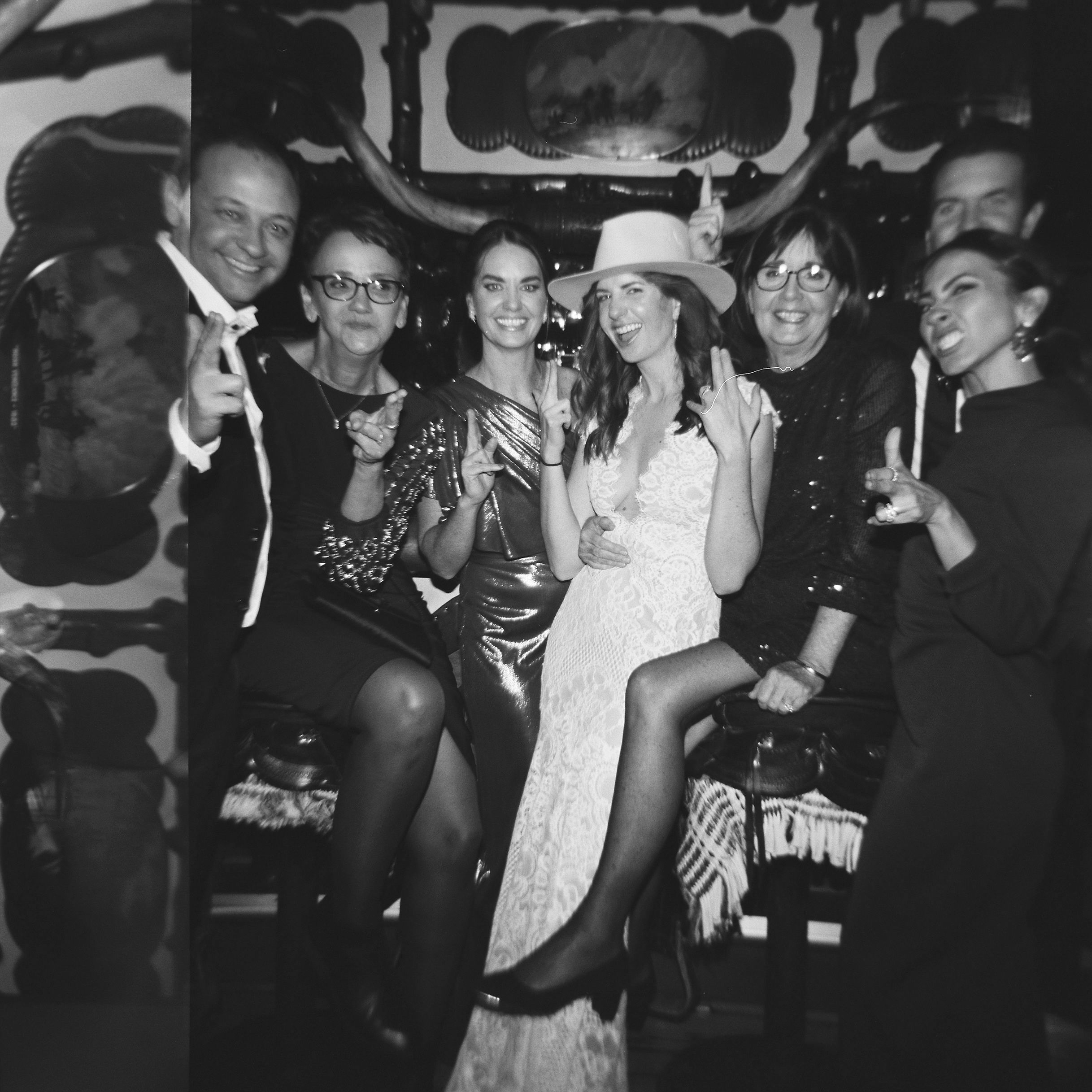 bride with her wedding guests in a black and white photo