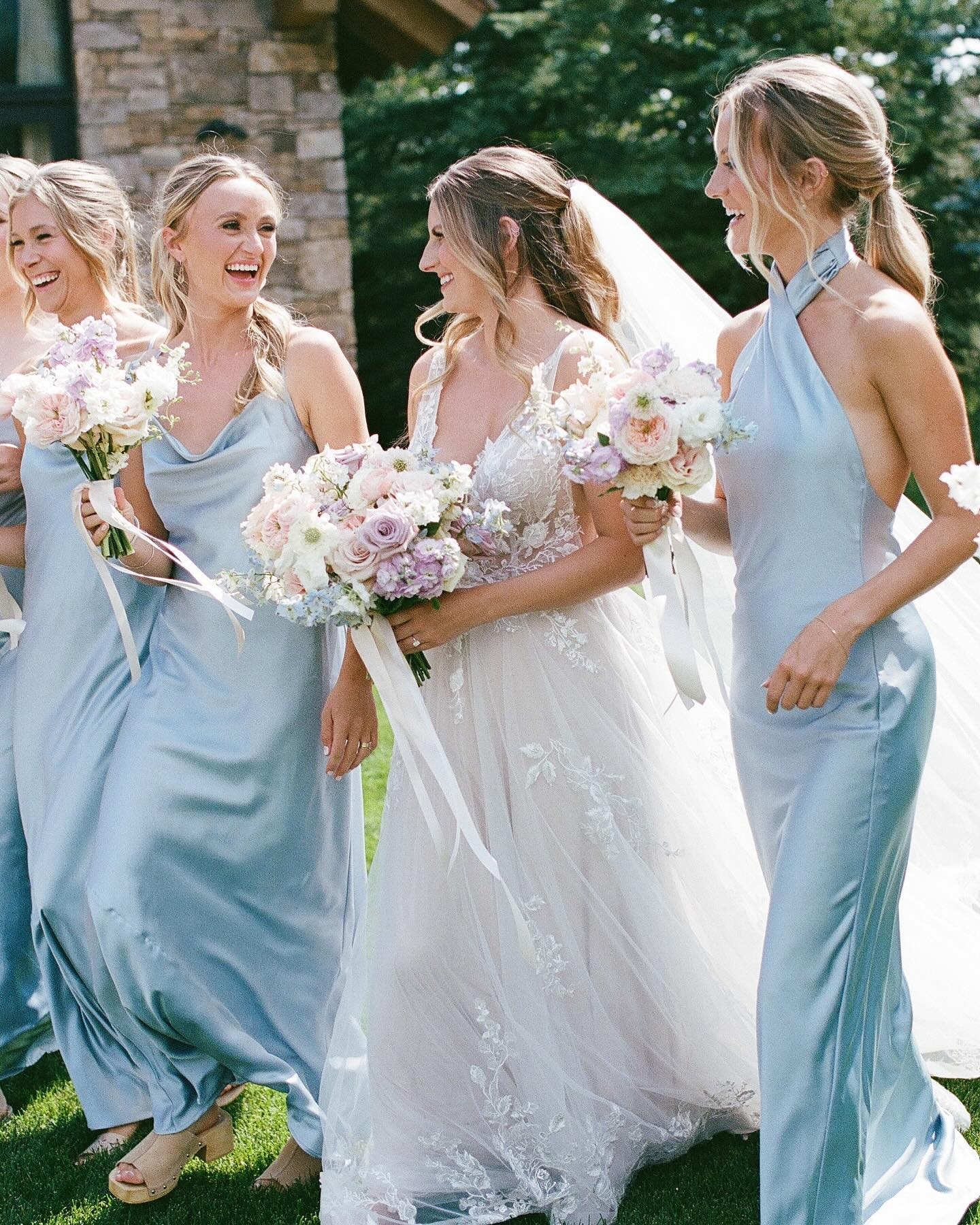 eloping-in-jackson-hole bride walking with her bridesmaids dressed in blue - wedding weekend itinerary