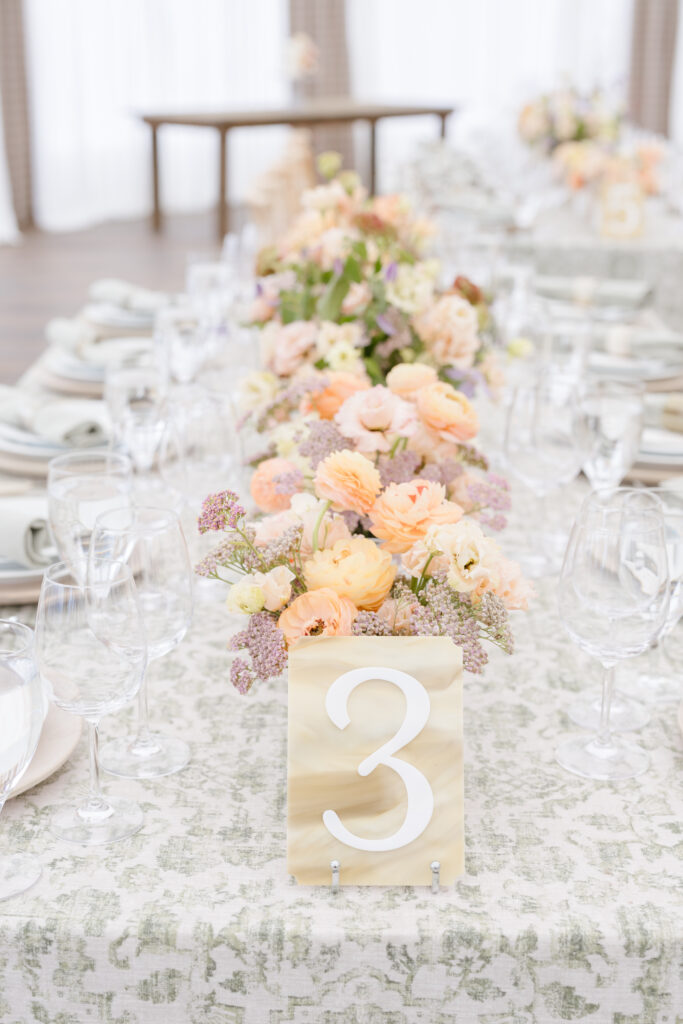 Elegant table number and floral centerpiece styled by top wedding planners in Jackson Hole. 