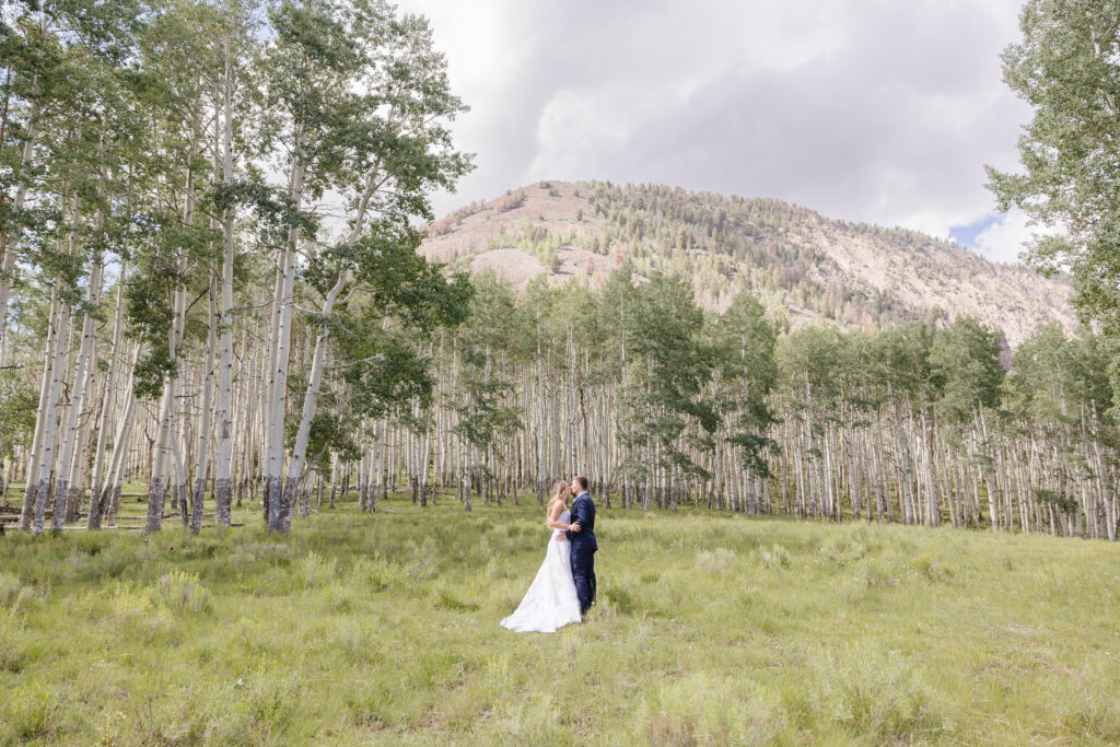 a couple walking through the grass - Wedding Ceremony Locations
