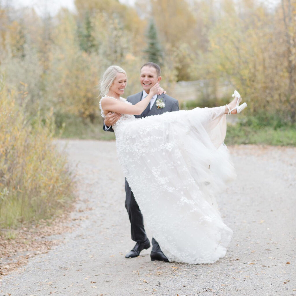 groom carrying the bride while Eloping with Family