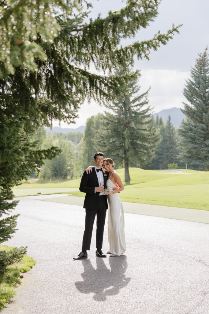 wedding couple posing outside at jackson hole golf and tennis club