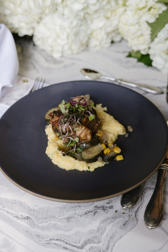 Elegant plated dinner at Jackson Hole Golf and Tennis Club, featuring local flavors and refined presentation.