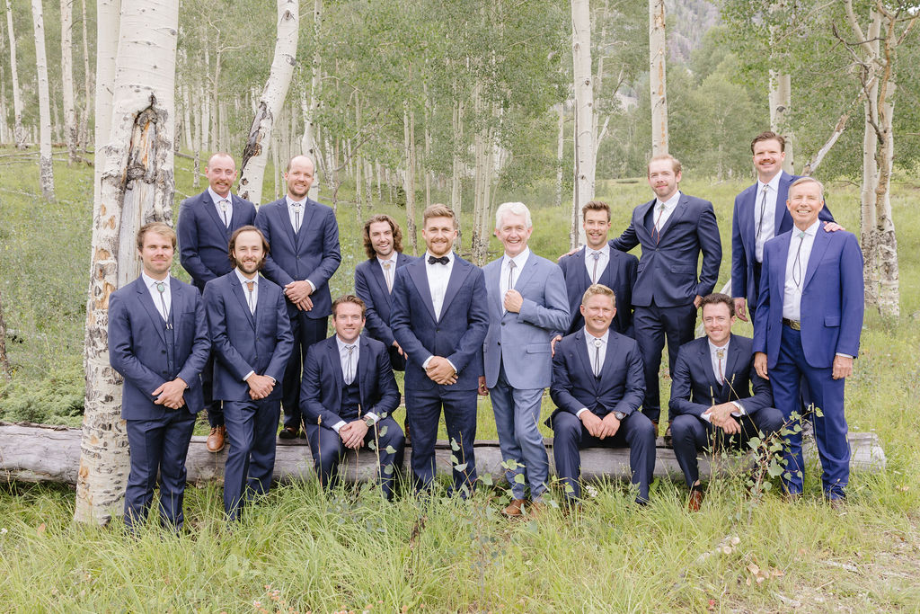Groomsmen pose together for photo.