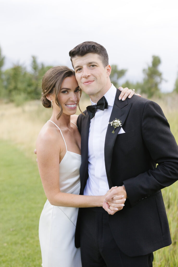Bride and groom pose together in Jackson Hole. 