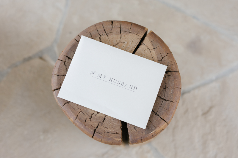 A sealed envelope sitting on a wood stump addressed to "my future husband."