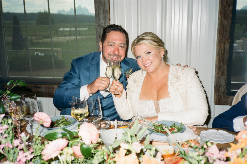 Bride and groom toast during their Wyoming elopement reception.