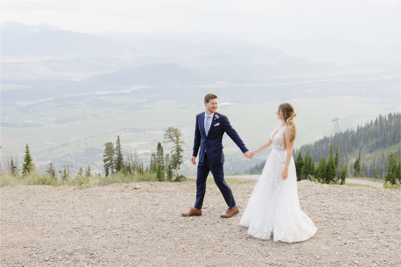 Bride and groom walk together at one of the most beautiful Wyoming wedding locations.