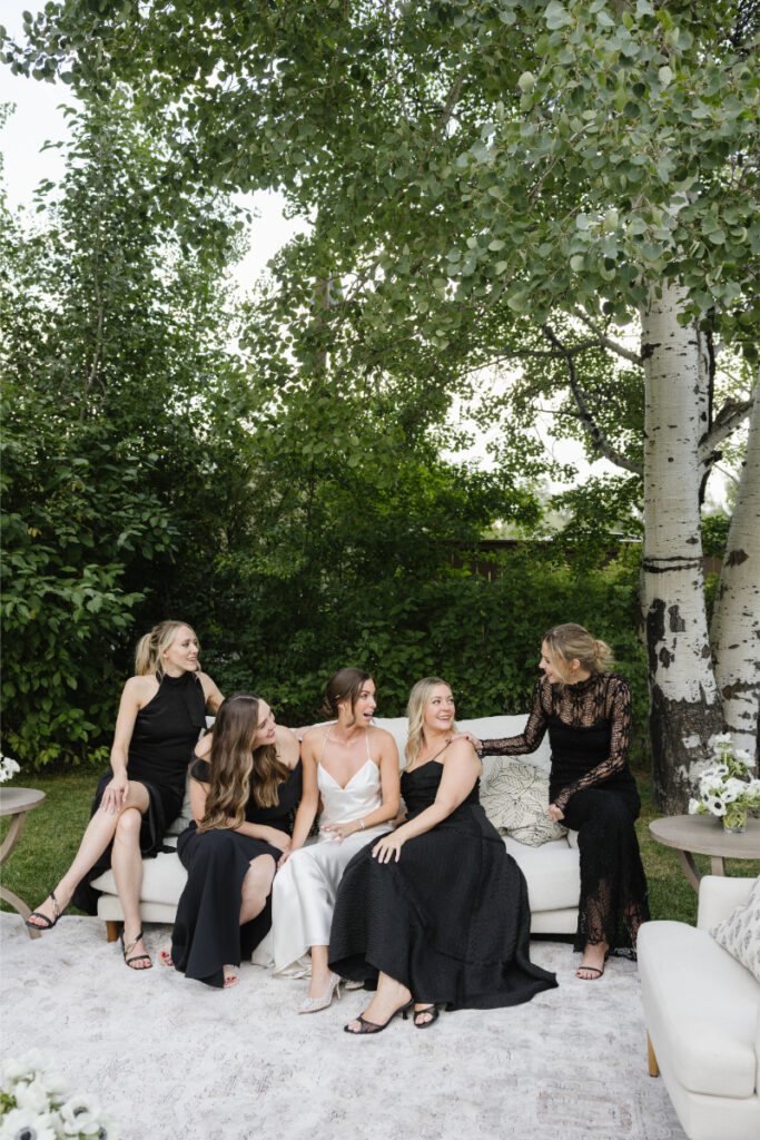 Bride sits with close friends after choosing between an elopement vs. wedding.