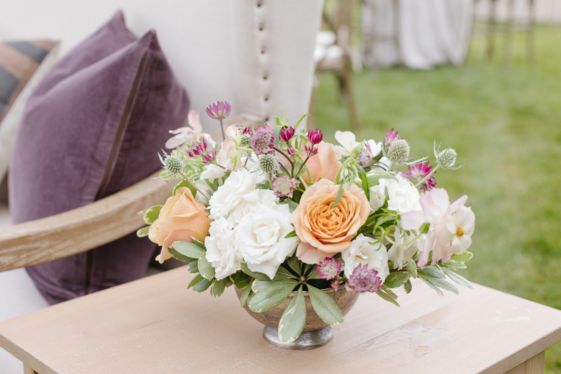 Floral arrangement next to lounge seating.
