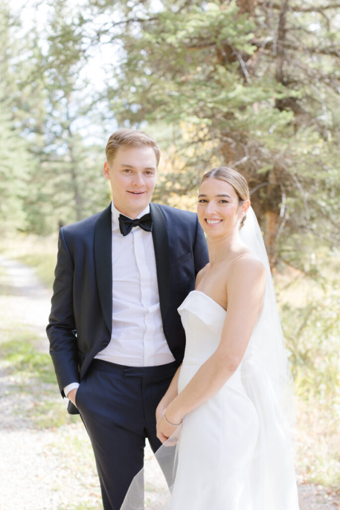 Bride and groom pose for couples portraits after their Moose Creek Ranch wedding.