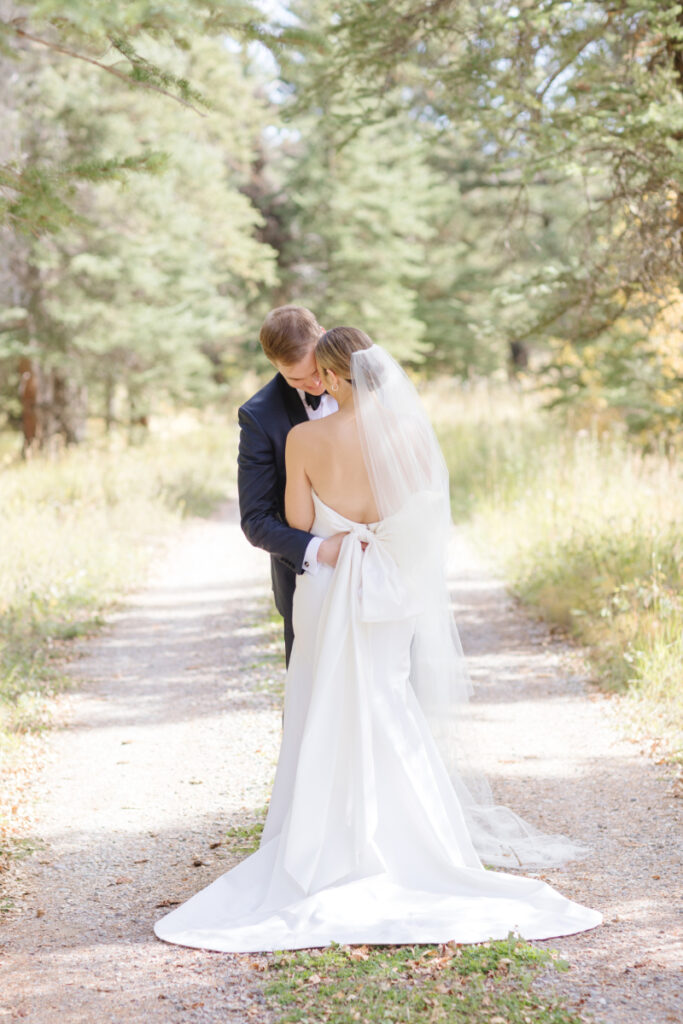 Bride and groom pose for couples portraits after their Moose Creek Ranch wedding.
