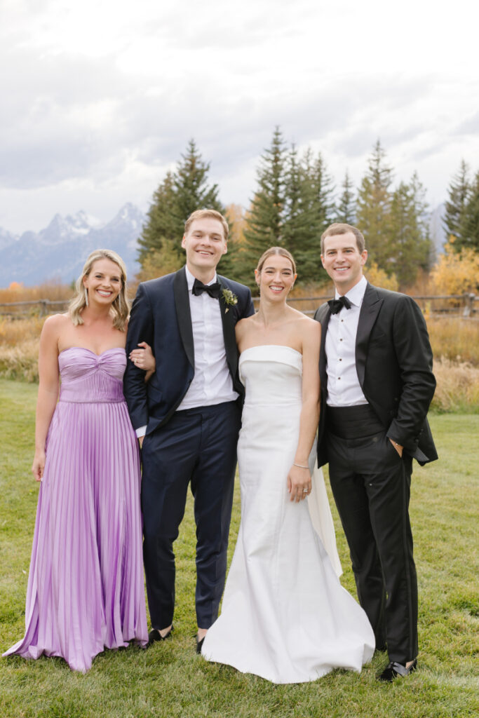Bride and groom pose with their maid of honor and best man during their Moose Creek Ranch wedding.