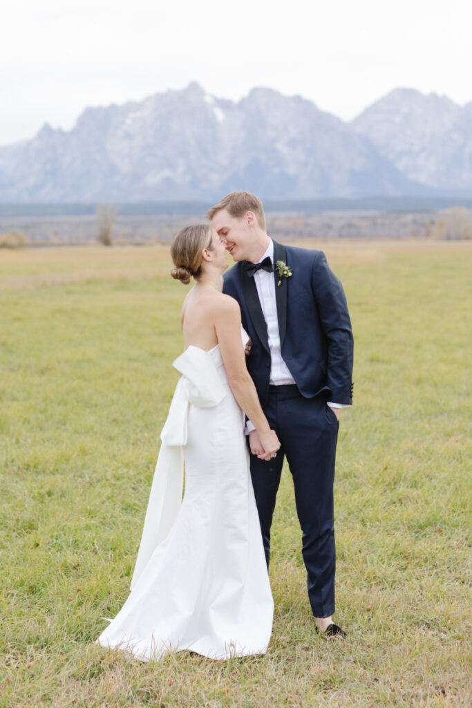 Bride and groom share kiss during couples portraits at their Moose Creek Ranch wedding.