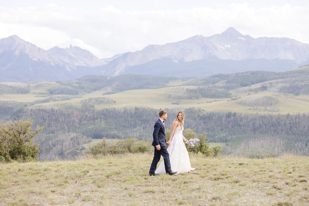 Bride and groom walk hand in hand in one of the most private places to elope in Jackson Hole.