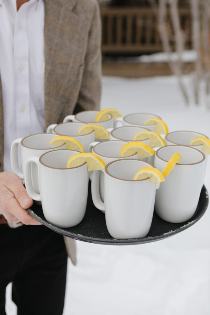 Tea sitting on serving tray to pass out to guests during outdoor winter elopement ceremony in Jackson Hole.