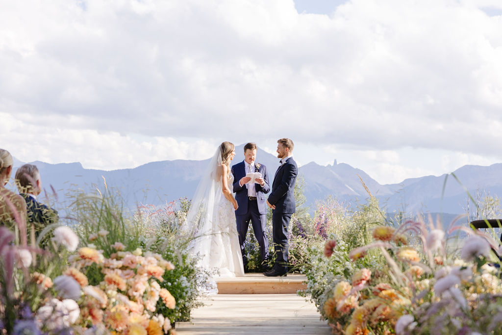 Bride and groom exchange vows during ceremony at their Jackson Hole weddings.