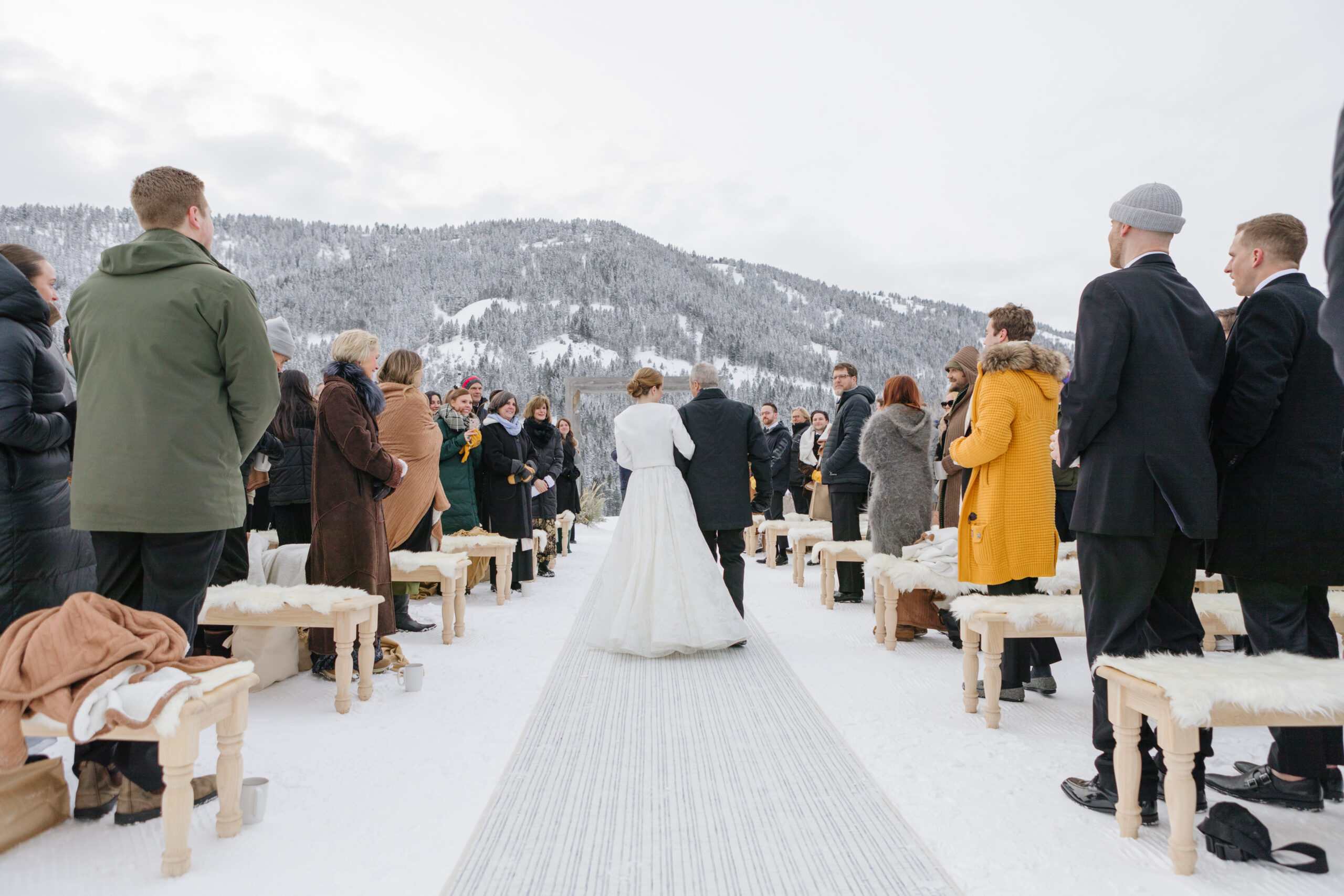 Father walks bride down the aisle during winter Jackson Hole weddings.