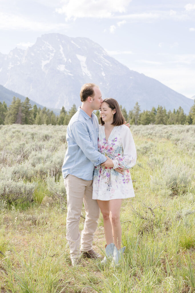 Man kissing his soon to be wife and their engagement photo at Jackson Hole.