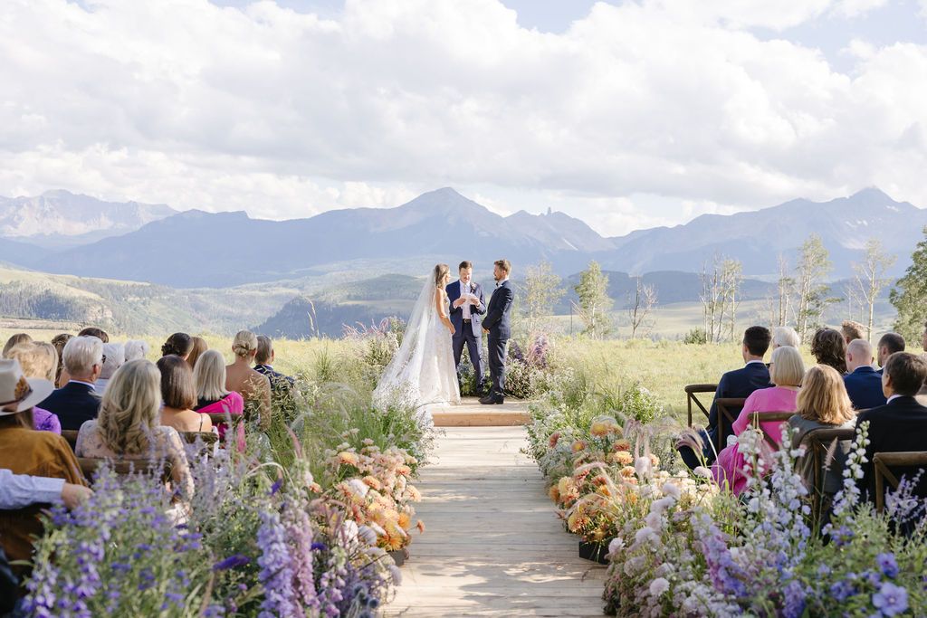 Bride and Groom in the alter as you over look the Jackson Hole Mountains as they showcase their small wedding venue.