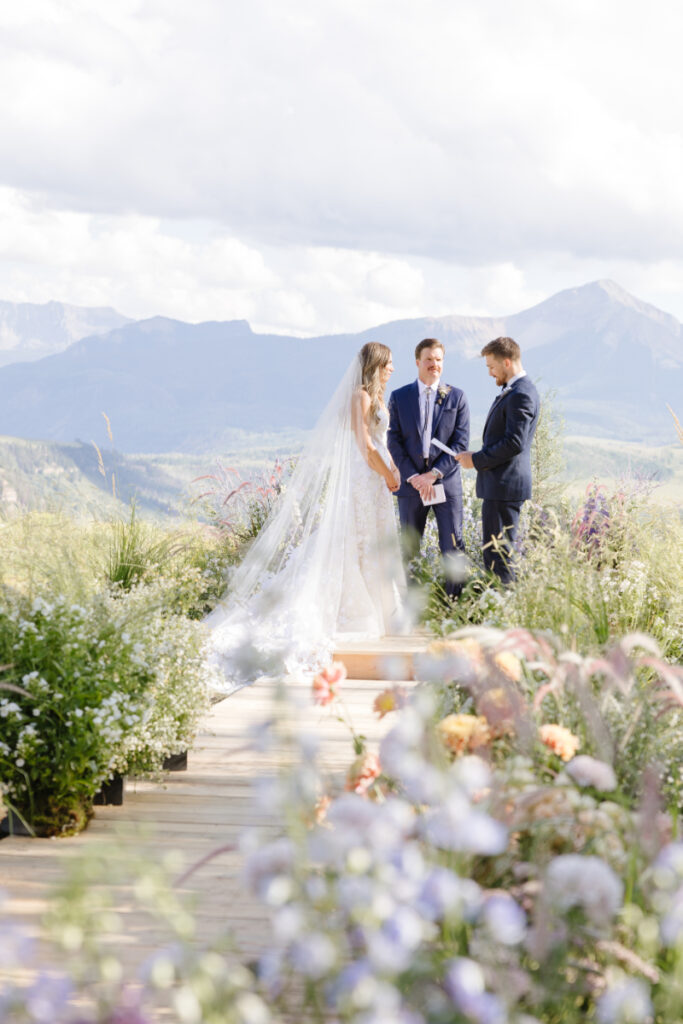 A Yellowstone National park wedding bride and groom at the alter with an amazing mountain drop background.