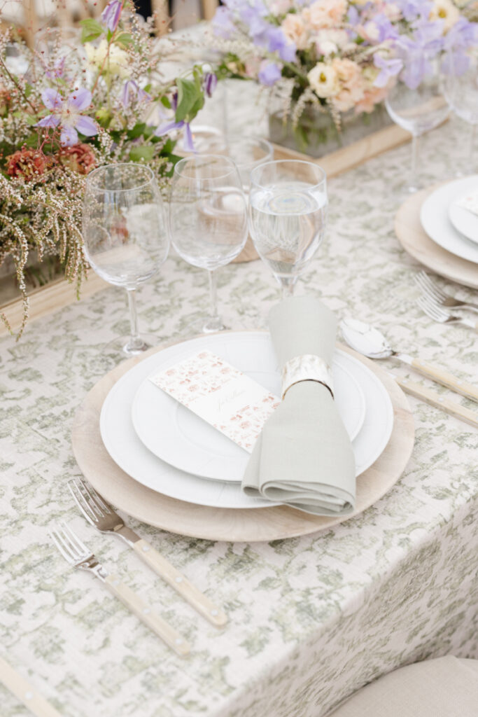 A Yellowstone National park wedding plate and dining decor with neutral colors and pastel flowers.