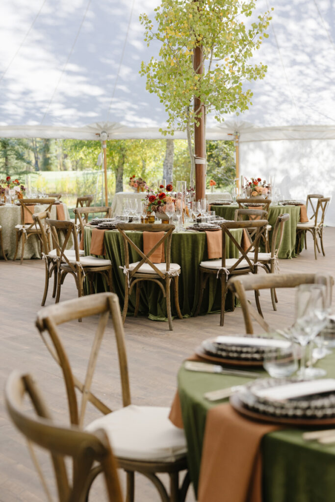 Elegant outdoor reception setup with decorated tables and greenery at a Grand Teton wedding