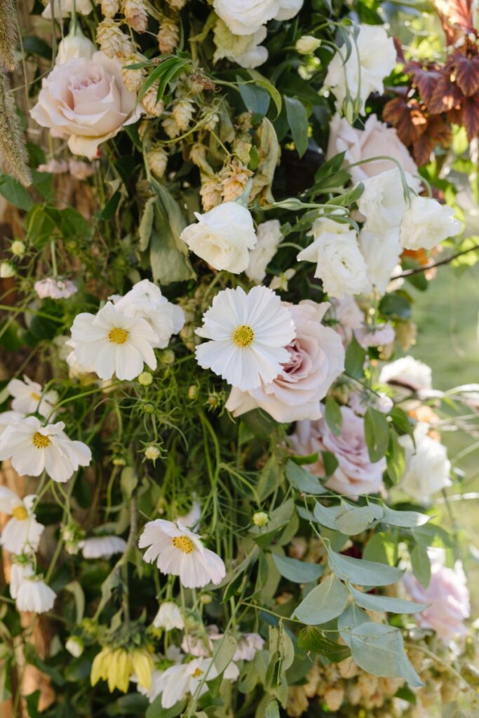 Close-up of soft, romantic wedding florals with roses and greenery, captured by Jackson Hole Photographers