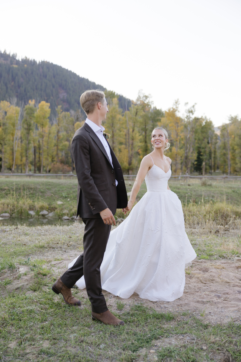 Bride and Groom looking into each other eyes as the Snake River Overlooks at the Grand Teton mountains.