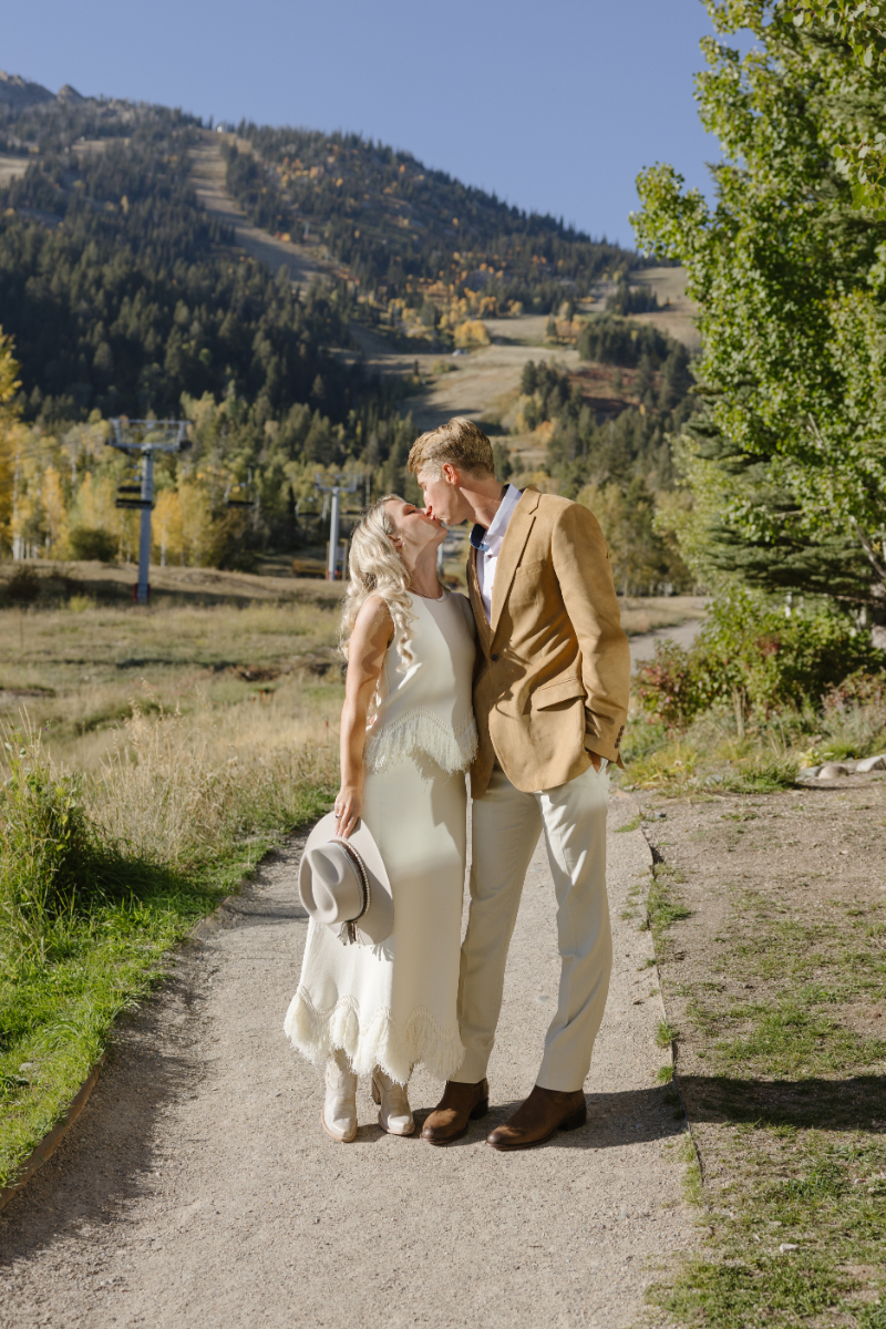 Couple kissing as the Snake River overlooks at the Grand Tetons.