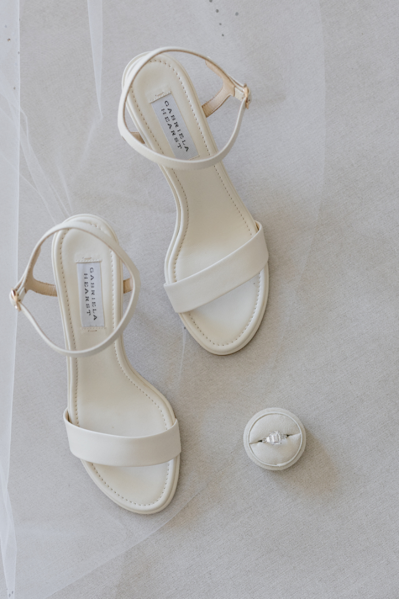 Brides white heels with ring.