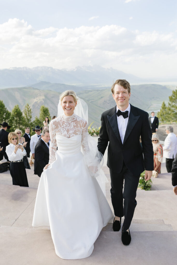 Husband and Wife walking out to the aisle after their mountain elopement.