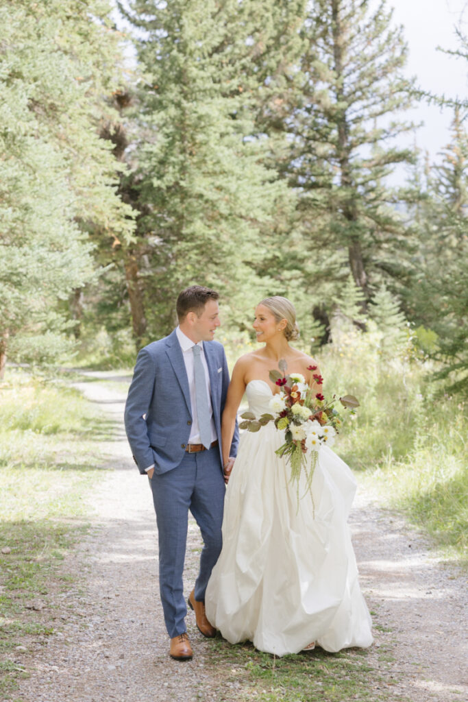 Bride and groom walking together on a ranch path in Jackson Hole