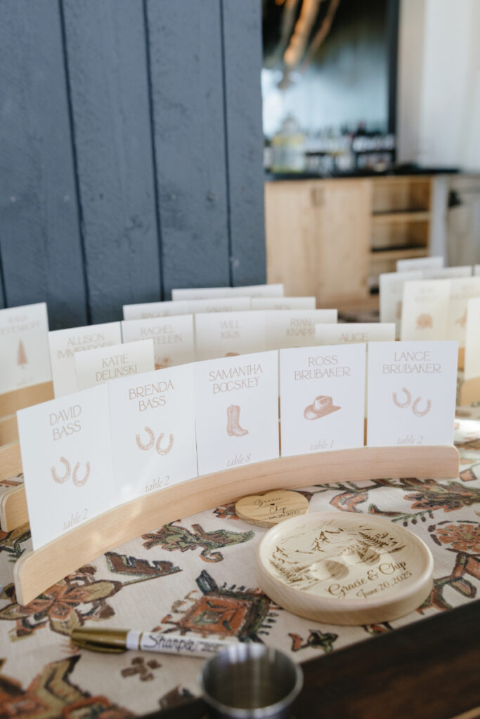 Western-inspired escort cards display at a Snow King Mountain wedding reception