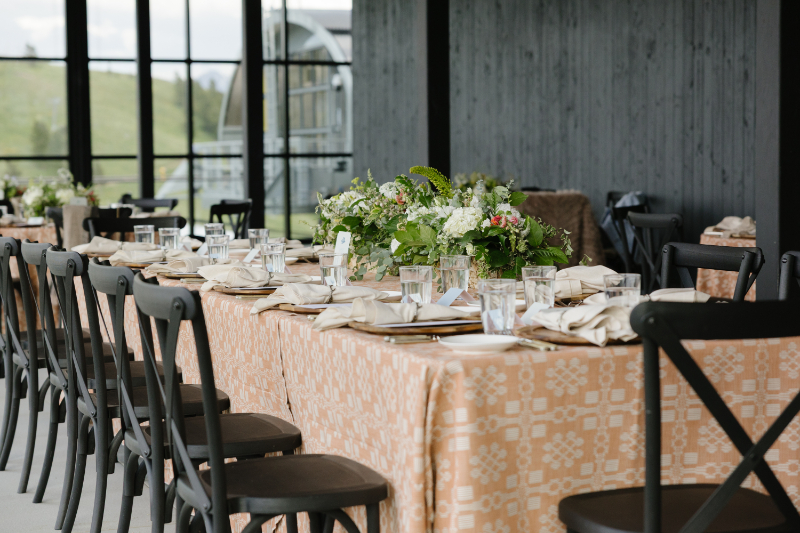 Long reception table with florals at a wedding at Summit House