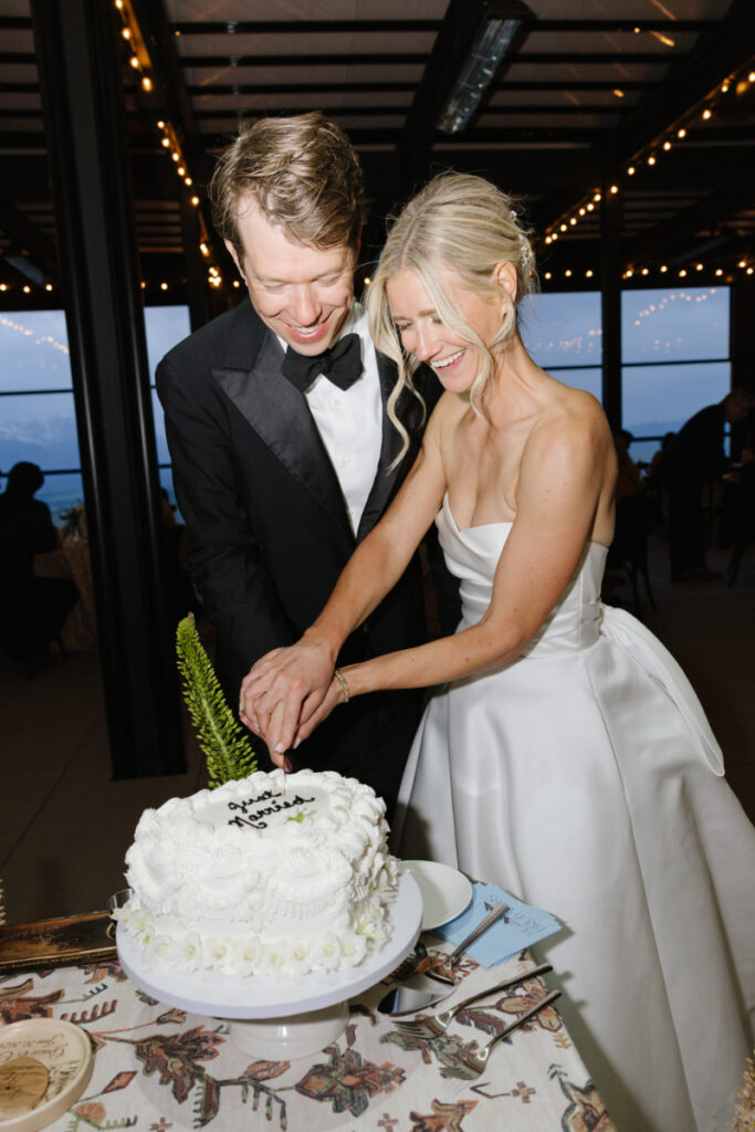 Bride and groom cutting their wedding cake during a Snow King Mountain wedding reception