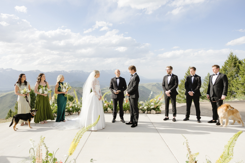 Bride and groom exchanging vows with their dogs at a Snow King Mountain wedding ceremony