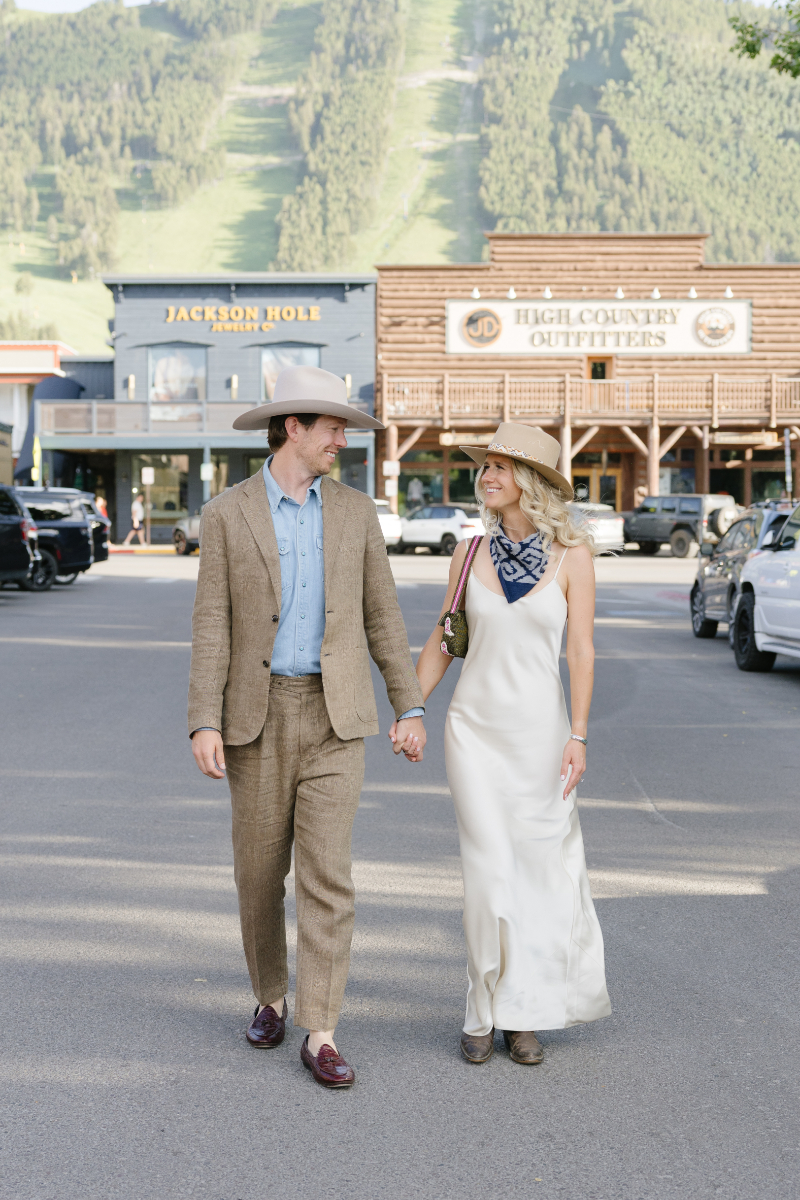 Couple walking through Jackson Hole town during their wedding weekend