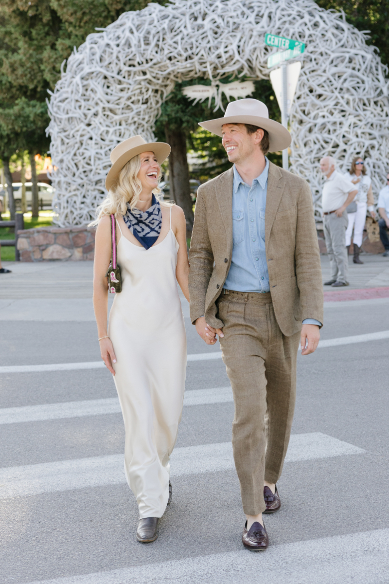 Couple walking under antler arches in Jackson Hole during their wedding weekend