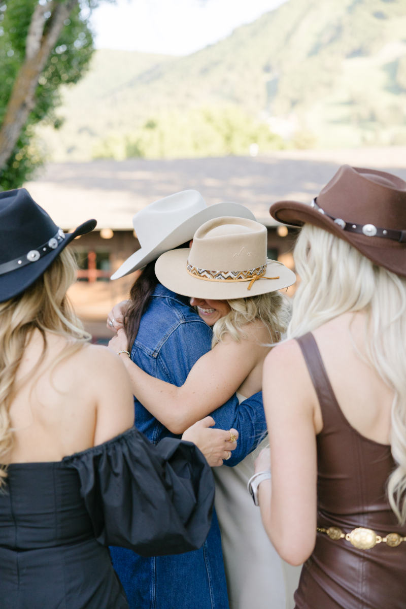 Bride hugging friends during a welcome party in Jackson Hole